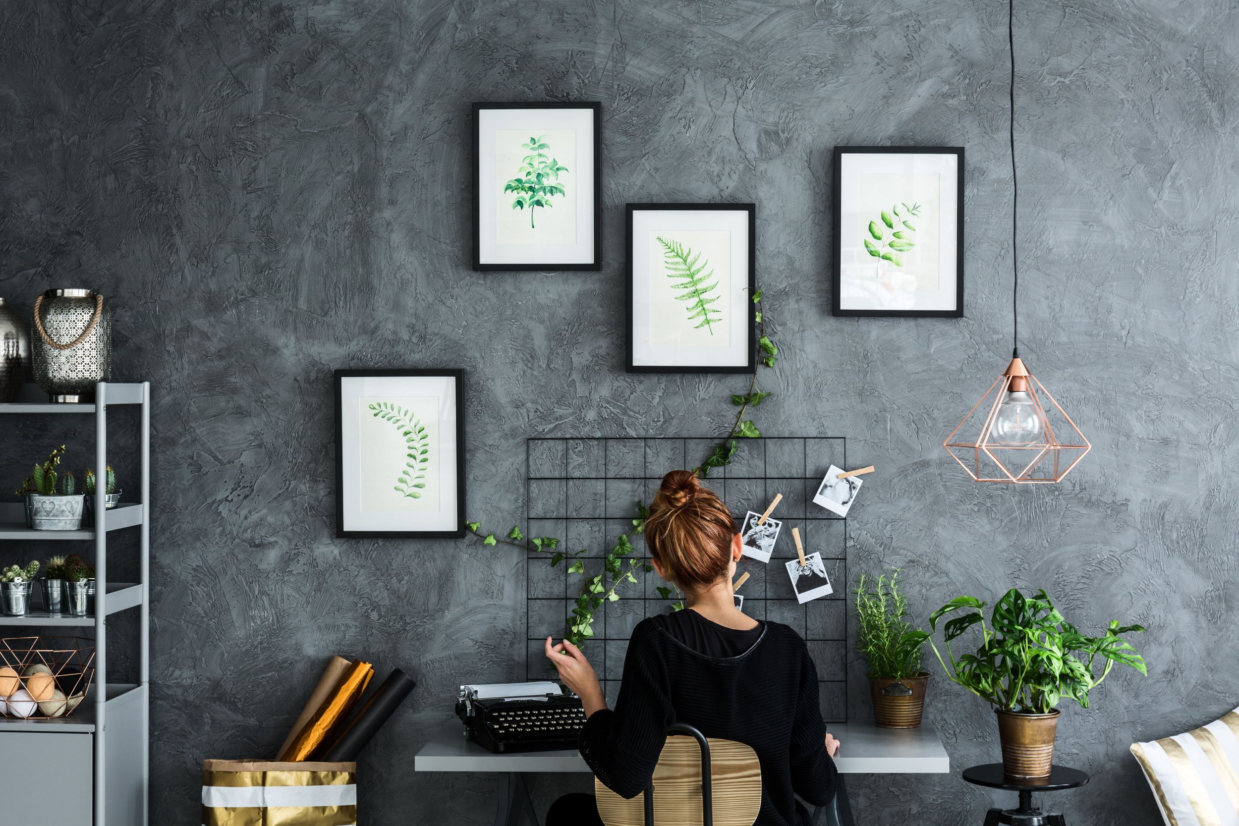 Woman sitting in front of a picture frame collection